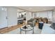 An open concept living room with hardwood floors, an open doorway to the kitchen, and a dining area at 5235 Dover St, Arvada, CO 80002