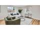 A bright and airy living room with a white sofa, area rug, and hardwood floors at 5235 Dover St, Arvada, CO 80002