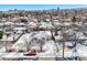 Aerial view of house and property in snowy neighborhood at 11842 W 14Th Ave, Lakewood, CO 80401