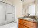 Bathroom features a sliding glass door shower and wooden vanity with a granite countertop at 61 S Sable Blvd # C15, Aurora, CO 80012