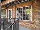 This exterior entrance features a secure door, window view, and brick exterior accents at 61 S Sable Blvd # C15, Aurora, CO 80012