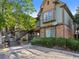 Multi-level townhome featuring brick and siding accents, landscaped front, and staircase entry to upper units at 61 S Sable Blvd # C15, Aurora, CO 80012