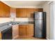 Bright kitchen with wooden cabinets, granite countertops, stainless steel appliances, and wood floors at 61 S Sable Blvd # C15, Aurora, CO 80012