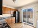 Kitchen features stainless steel appliances, granite countertops, wooden cabinets, and wood floors at 61 S Sable Blvd # C15, Aurora, CO 80012