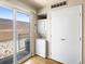 Features a laundry closet with a washer and dryer, with sliding glass doors to the outdoor patio at 61 S Sable Blvd # C15, Aurora, CO 80012