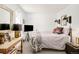 Bedroom featuring a full bed, wall sconces, side table, with neutral decor at 432 N Ogden St, Denver, CO 80218