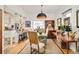 Open dining room featuring an eclectic table, vintage chairs, and view into kitchen at 432 N Ogden St, Denver, CO 80218