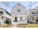 Charming two-story home with a covered porch and landscaped front yard creates an inviting curb appeal at 432 N Ogden St, Denver, CO 80218