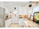 Bright kitchen with white cabinets, stone counters and a door to the backyard at 432 N Ogden St, Denver, CO 80218