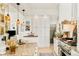 Bright kitchen features white cabinetry, granite countertops, an island and stainless appliances at 432 N Ogden St, Denver, CO 80218