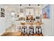 Modern kitchen with white cabinetry, granite countertops, and stylish barstool seating at 432 N Ogden St, Denver, CO 80218