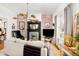 Cozy living room featuring a brick accent wall, fireplace, and hardwood floors at 432 N Ogden St, Denver, CO 80218