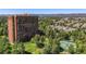 High-rise condo building with pond and tennis courts surrounded by mature green trees at 1900 E Girard Pl # 1103, Englewood, CO 80113