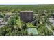 High rise building surrounded by mature trees and manicured lawn with tennis courts at 1900 E Girard Pl # 1103, Englewood, CO 80113