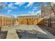 View of a backyard featuring a concrete patio area and secure wooden fencing at 748 Elati St, Denver, CO 80204