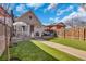 Expansive backyard features artificial turf, a patio with outdoor seating, and a lush green lawn at 748 Elati St, Denver, CO 80204