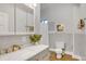 Bright bathroom featuring a modern sink, stylish fixtures, and a tiled shower and bath area at 748 Elati St, Denver, CO 80204