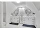 Bright bathroom features dual sinks, white cabinetry, black accents and stylish round mirrors at 748 Elati St, Denver, CO 80204