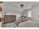 Cozy bedroom with sloped ceilings features neutral decor, wood dresser, and a built-in desk at 748 Elati St, Denver, CO 80204