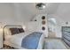 Comfortable bedroom features plush bedding, stylish decor, neutral colors, and a glimpse into the hallway at 748 Elati St, Denver, CO 80204