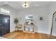 Bright entryway with hardwood floors, modern light fixture, and stylish décor at 748 Elati St, Denver, CO 80204