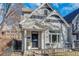 Charming home with detailed trim, a small front yard, and a cozy, welcoming entryway at 748 Elati St, Denver, CO 80204