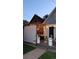 Backyard patio featuring a pergola, string lights, comfortable seating, potted plants, and manicured lawn at 748 Elati St, Denver, CO 80204