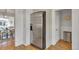 Stainless steel refrigerator adjacent to an open dining and living area with wood floors at 748 Elati St, Denver, CO 80204