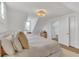 Spacious bedroom featuring pitched ceilings, carpet and a decorative light fixture at 748 Elati St, Denver, CO 80204