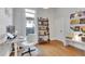 Well-lit office with wooden floors, shelving, and a view to the outside at 748 Elati St, Denver, CO 80204