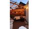 Outdoor patio with wooden pergola, string lights, comfortable seating, and decorative plants for relaxing evenings at 748 Elati St, Denver, CO 80204