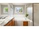 Bright bathroom featuring a soaking tub, shower, and a window with great natural light at 3461 Maple Cir, Brighton, CO 80601