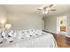 Comfortable bedroom with a modern ceiling fan and decor with an attached bathroom at 3461 Maple Cir, Brighton, CO 80601