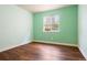 Cozy bedroom with verdant green walls and bright natural light from the window at 3461 Maple Cir, Brighton, CO 80601