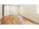 Light and airy bedroom with wood look floors, neutral walls, and a large window for natural light at 3461 Maple Cir, Brighton, CO 80601