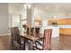 Dining room featuring hardwood floors, a large dining table, and easy access to the kitchen at 3461 Maple Cir, Brighton, CO 80601