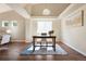 Cozy dining area featuring a modern light fixture, a light-colored wall, and hardwood floors at 3461 Maple Cir, Brighton, CO 80601