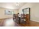 Formal dining room with hardwood floors, plenty of seating, and a cabinet for storing glassware at 3461 Maple Cir, Brighton, CO 80601