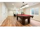 Finished basement offers billiard table, hardwood flooring, and ample space for entertaining at 3461 Maple Cir, Brighton, CO 80601
