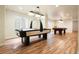 Finished basement game room with air hockey, pool table, and hardwood flooring at 3461 Maple Cir, Brighton, CO 80601