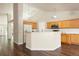 Open kitchen showcasing island with marble countertops, stainless appliances, white subway tile backsplash, and ample wooden cabinetry at 3461 Maple Cir, Brighton, CO 80601