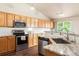 Modern kitchen featuring stainless steel appliances, granite countertops, and ample cabinet space at 3461 Maple Cir, Brighton, CO 80601