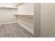 Spacious walk-in closet with wood look floors, shelving and ample storage space at 3461 Maple Cir, Brighton, CO 80601