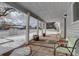 Covered porch with two green chairs and wooden barrels. Snowy yard in background at 6355 W Jefferson Pl, Lakewood, CO 80226