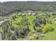 Breathtaking aerial view showcasing community homes amidst sprawling greenery at 766 Chimney Creek Dr, Golden, CO 80401