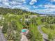 Scenic aerial view of community homes, a pool, and a pond surrounded by lush greenery at 766 Chimney Creek Dr, Golden, CO 80401