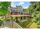 Home's backyard features large deck with outdoor seating with lush greenery at 766 Chimney Creek Dr, Golden, CO 80401
