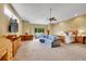 Spacious main bedroom features a ceiling fan, large windows, and seating area at 766 Chimney Creek Dr, Golden, CO 80401