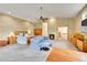 Large bedroom features a ceiling fan, seating area, fireplace, and two dressers at 766 Chimney Creek Dr, Golden, CO 80401