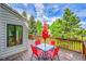 Outdoor deck features a table with red chairs, great views, and a relaxing atmosphere at 766 Chimney Creek Dr, Golden, CO 80401
